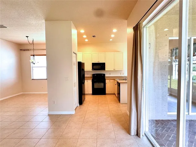 a view of a kitchen with a sink and a refrigerator