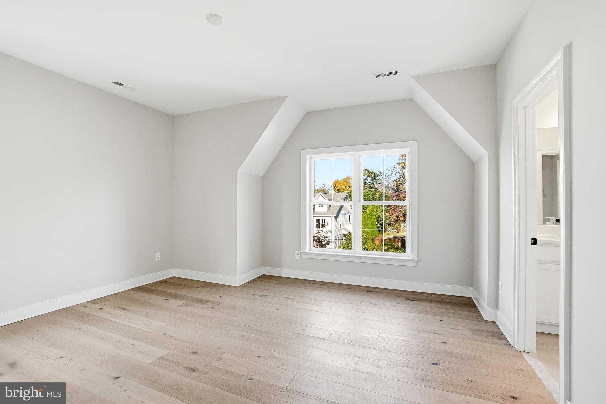 8802 Ridge Road Bethesda, MD 20817 - Photo 19 of 26 an empty room with wooden floor and windows