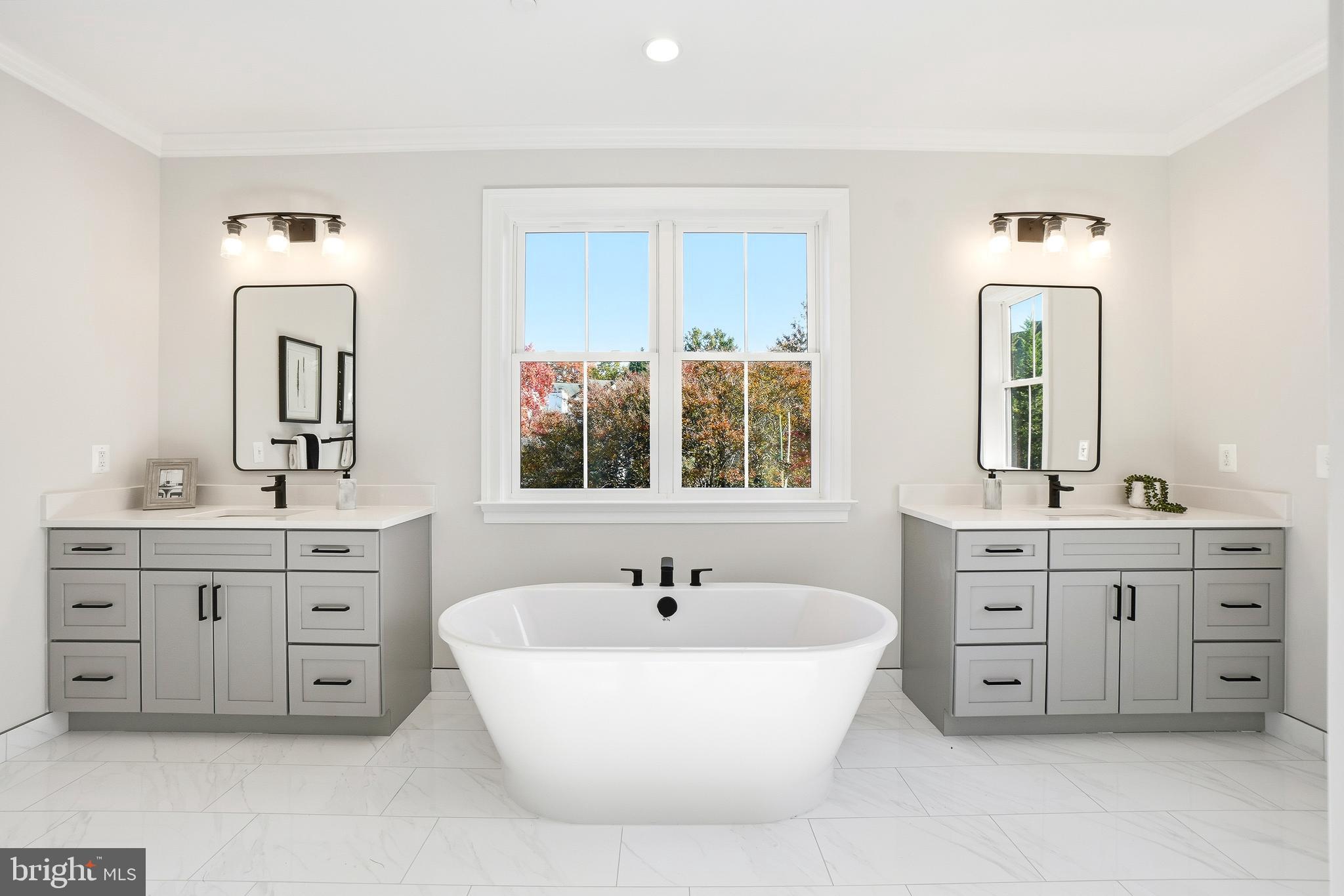 8802 Ridge Road Bethesda, MD 20817 - Photo 22 of 26 a spacious bathroom with double vanity sink a two mirror a window a bathtub and vanity