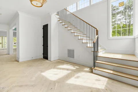 a view of entryway with wooden floor and front door