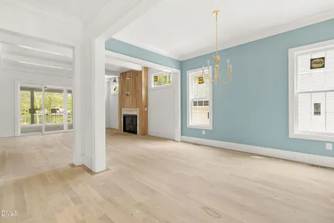 an empty room with windows and cabinet