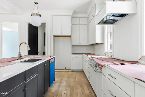 a kitchen with a sink stove and cabinets