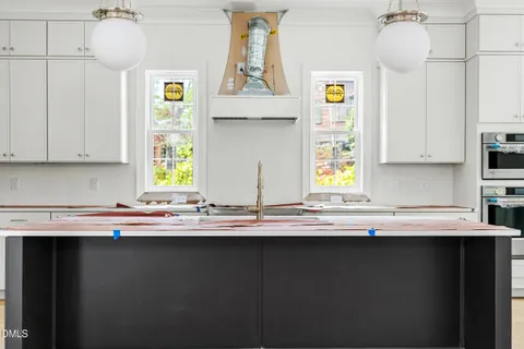a kitchen with a sink a window and cabinets