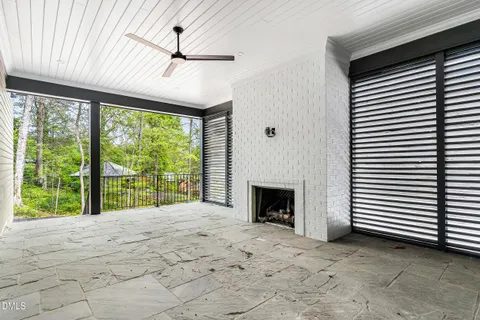 a view of an empty room with a fireplace and a window