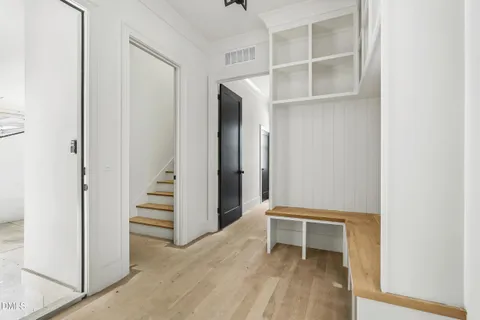 a view of an empty room with stairs and ventilation