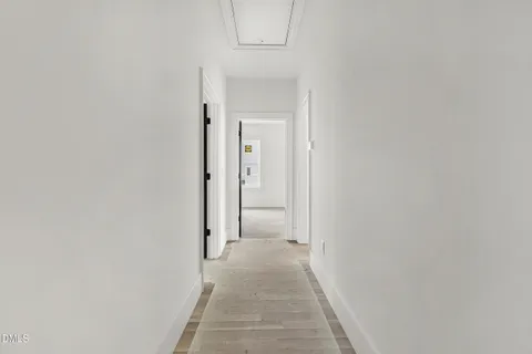 a view of a hallway with white walls