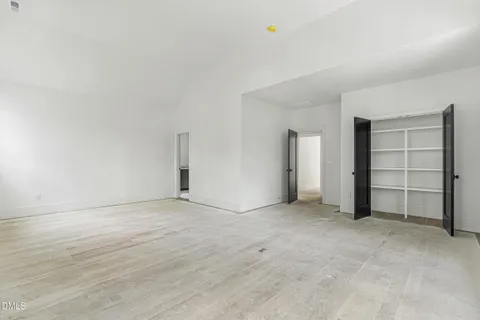 an empty room with a closet and cabinet