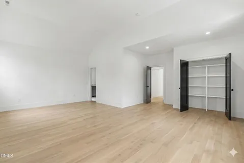 a view of an empty room with a closet and cabinet