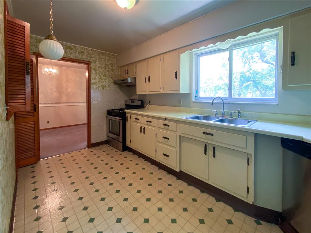 128 Clover Drive Monaca, PA 15061 - Photo 5 of 19 a kitchen with a sink a refrigerator and window