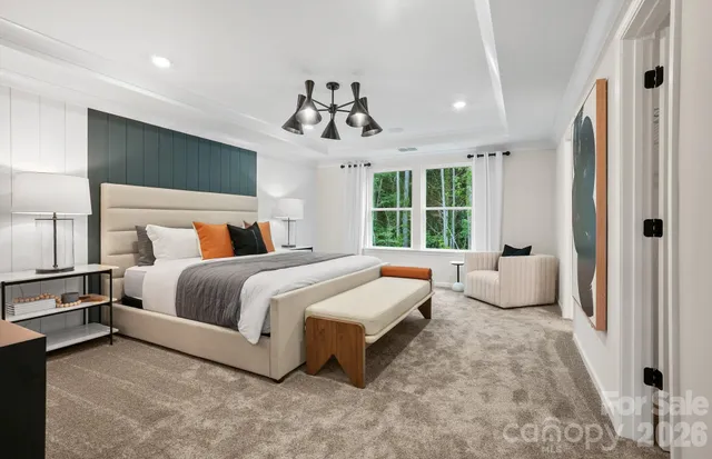 a spacious bedroom with a bed and window