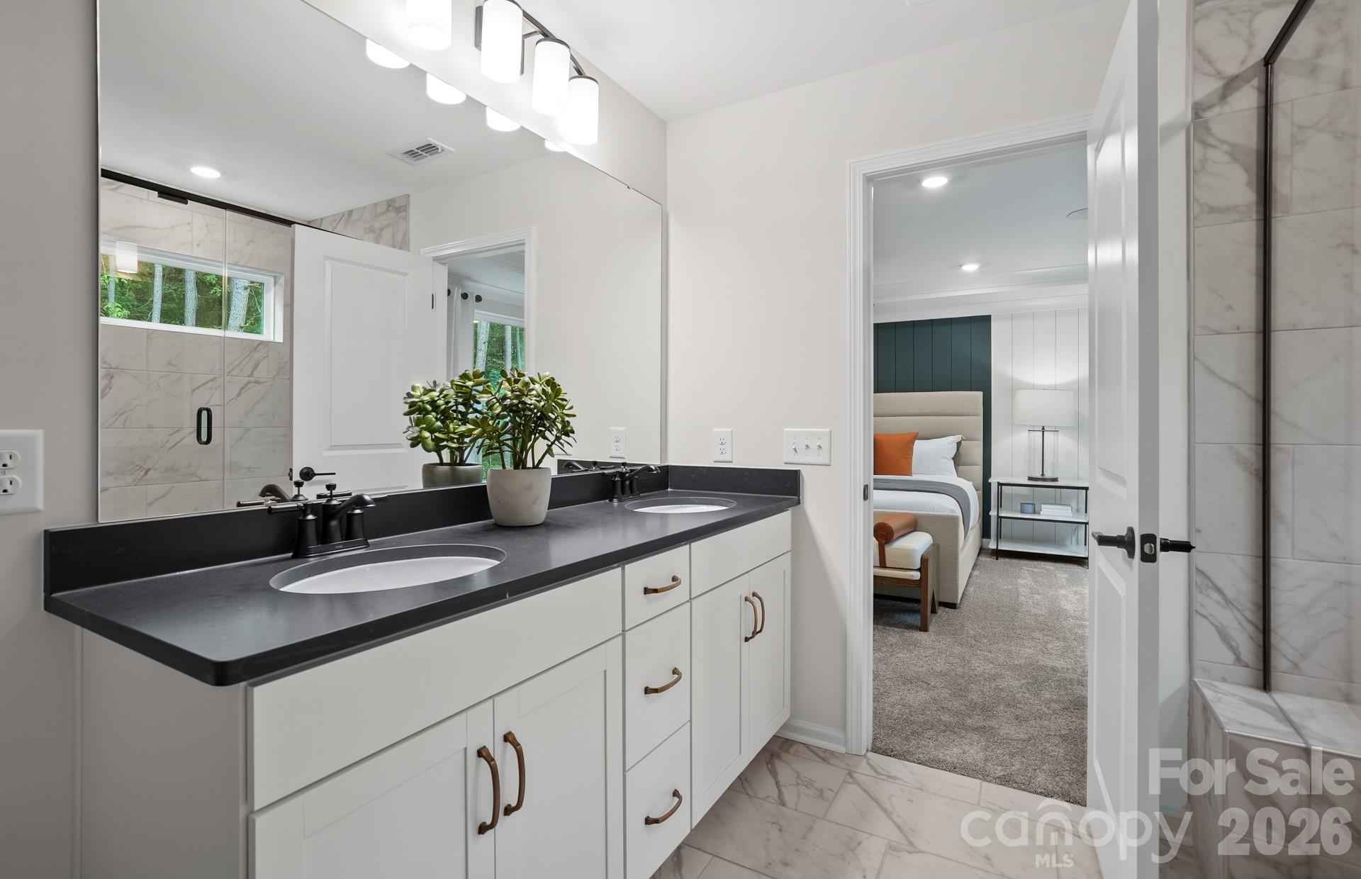 5807 Stewarts Lndg Road, Unit 62 Charlotte, NC 28215 - Photo 7 of 9 a spacious bathroom with a double vanity sink mirror and