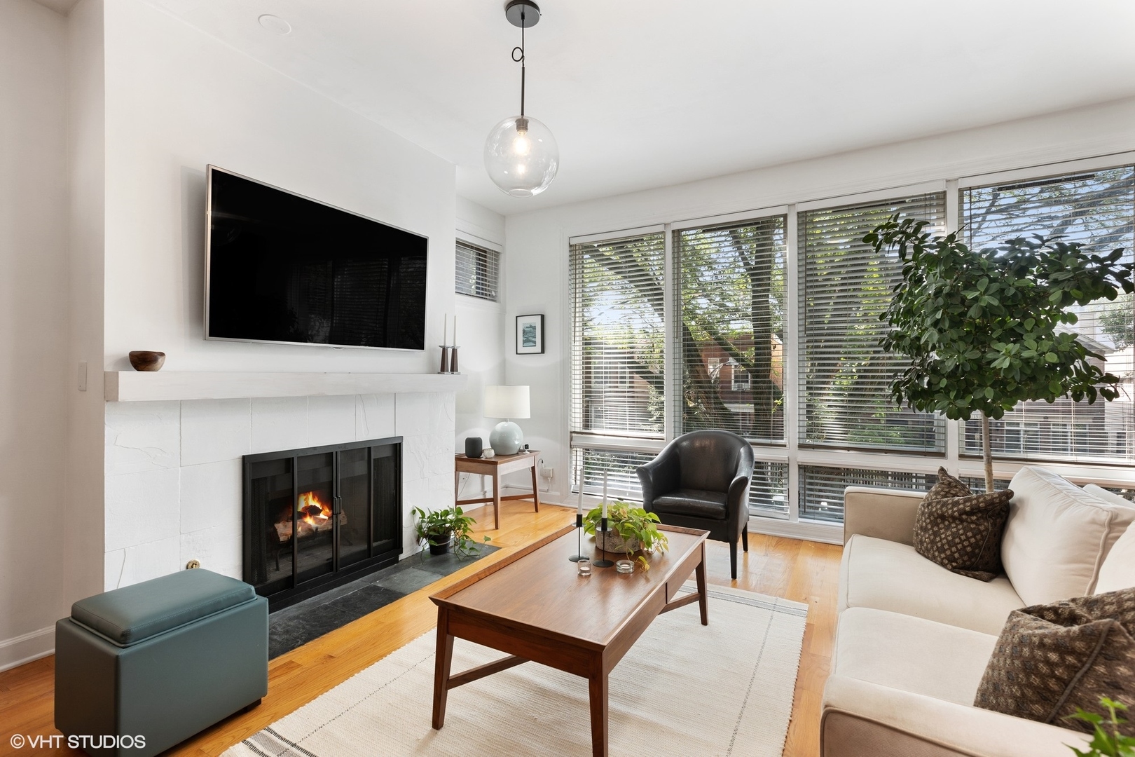 1512 West Victoria Street, Unit 2 Chicago, IL 60660 - Photo 2 of 19 a living room with furniture a large window and a fireplace