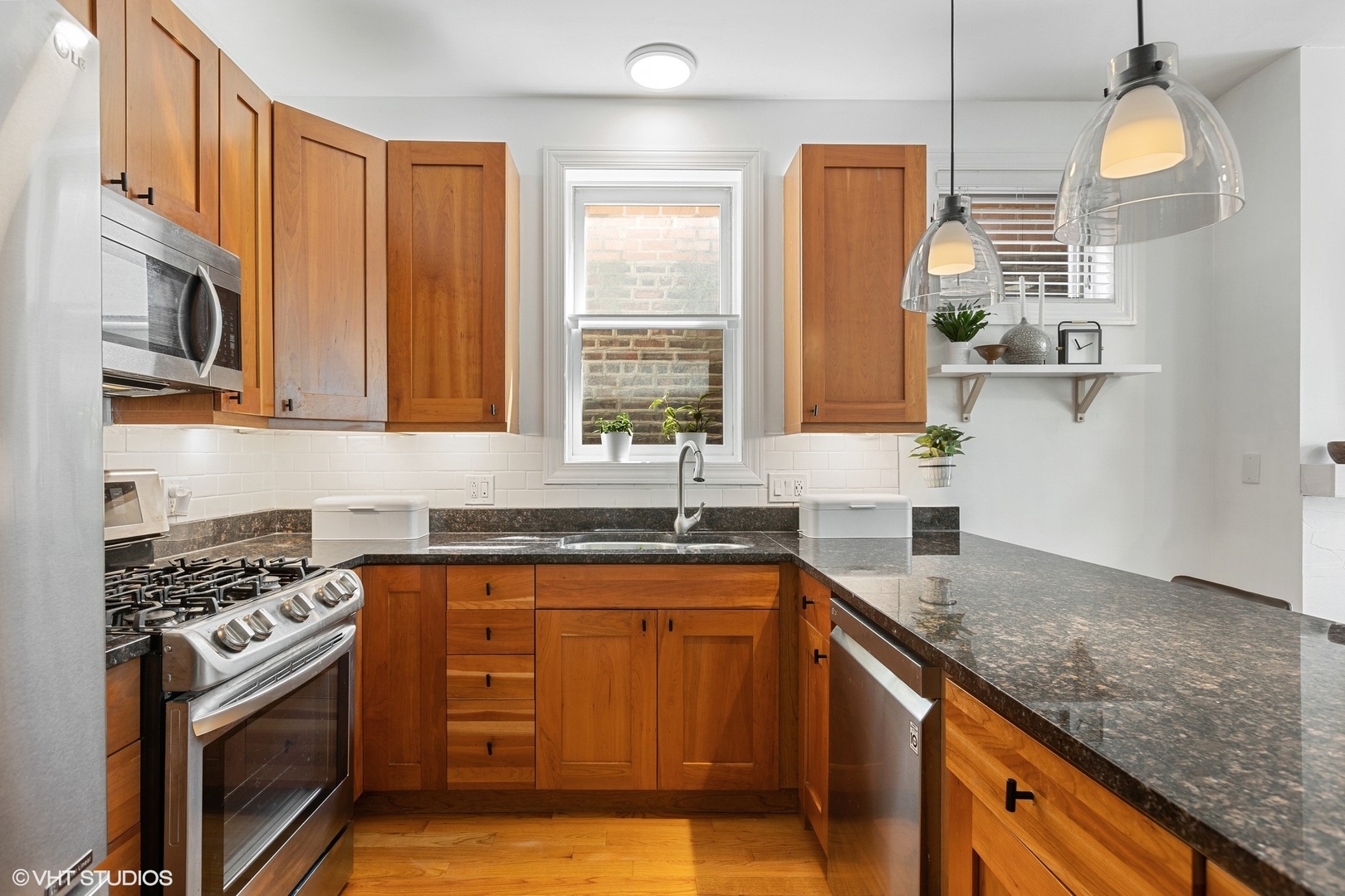 1512 West Victoria Street, Unit 2 Chicago, IL 60660 - Photo 11 of 19 a kitchen with stainless steel appliances granite countertop a sink stove and cabinets