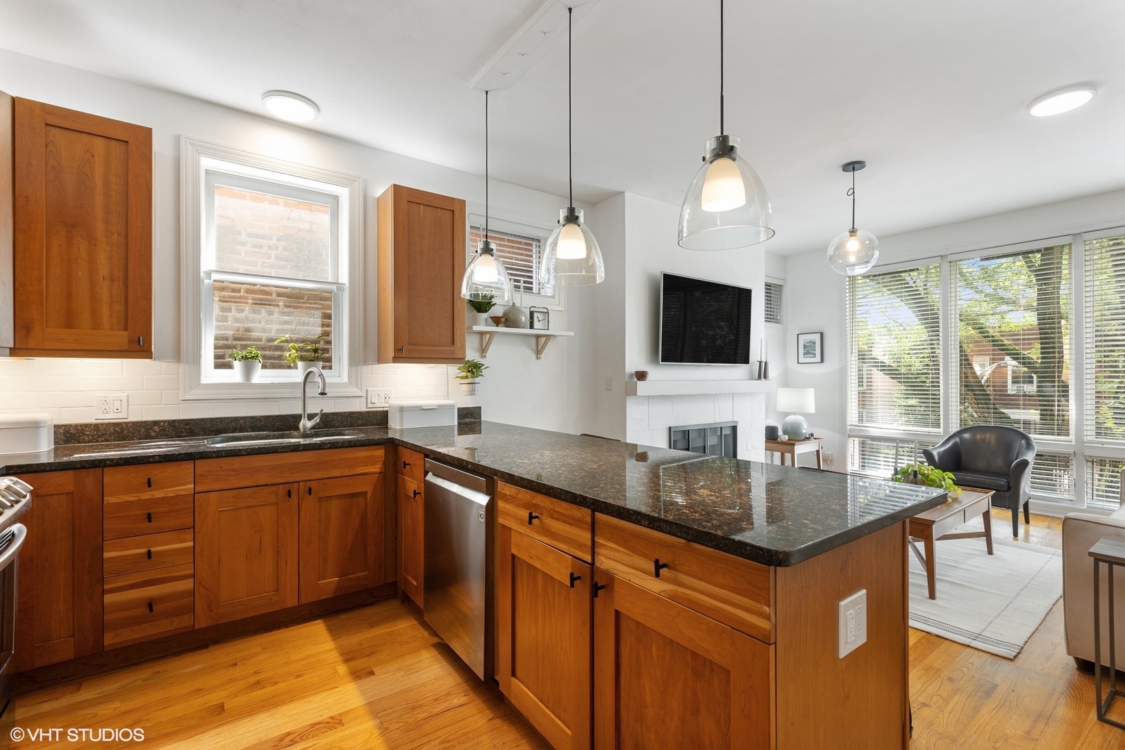 1512 West Victoria Street, Unit 2 Chicago, IL 60660 - Photo 12 of 19 a kitchen with granite countertop a sink and a wooden floor
