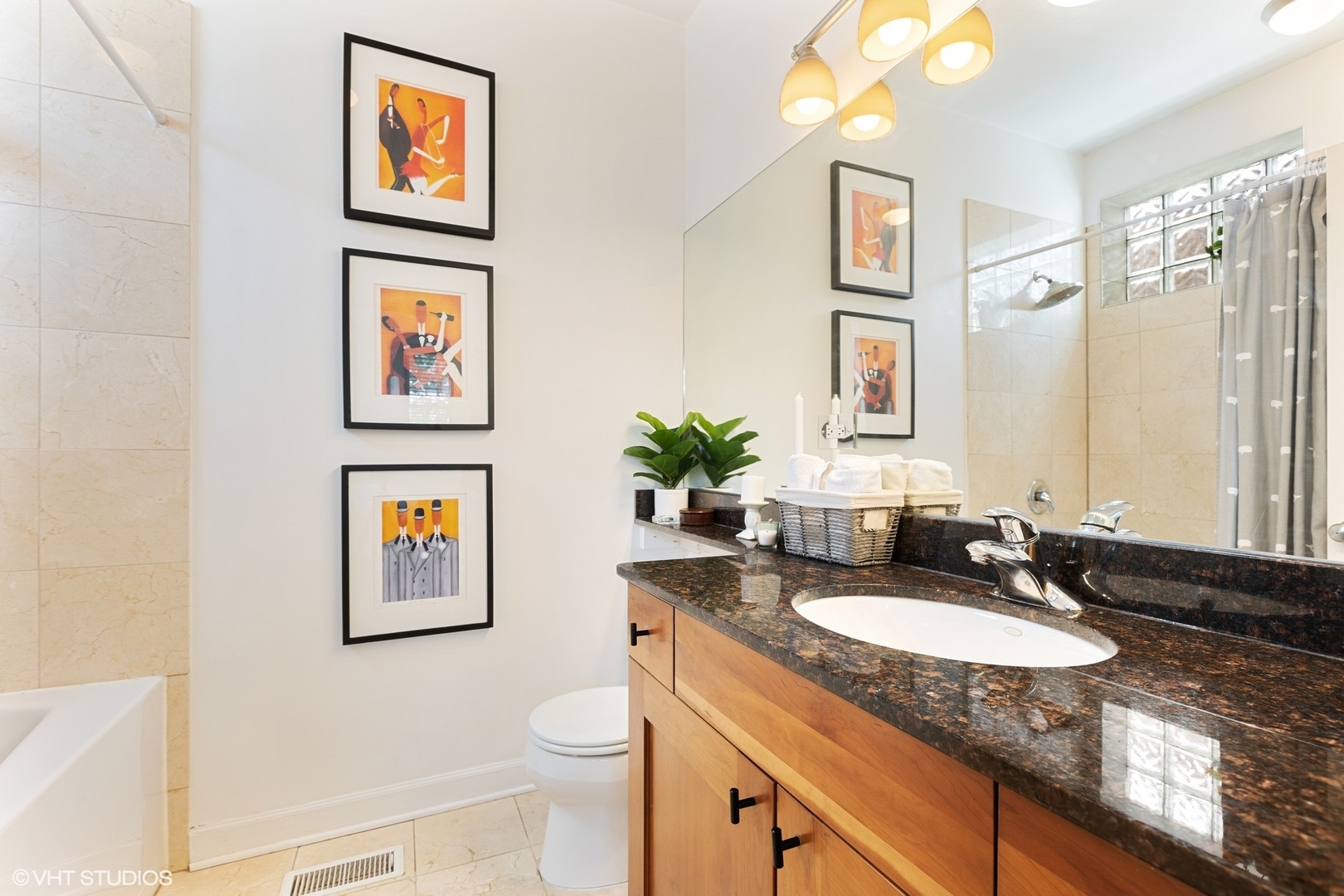 1512 West Victoria Street, Unit 2 Chicago, IL 60660 - Photo 17 of 19 a bathroom with a granite countertop sink and a mirror