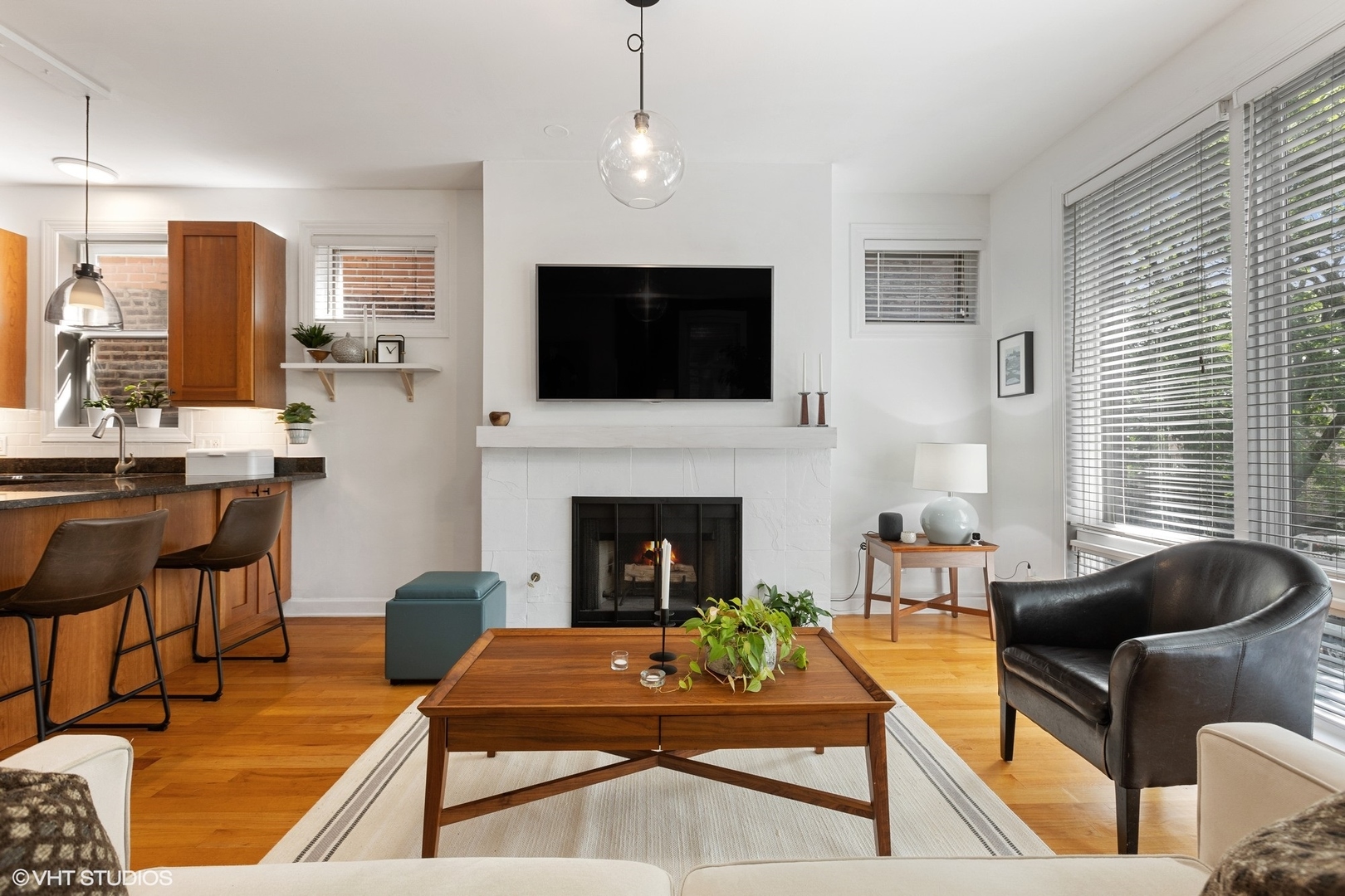 1512 West Victoria Street, Unit 2 Chicago, IL 60660 - Photo 4 of 19 a living room with furniture a flat screen tv and a fireplace