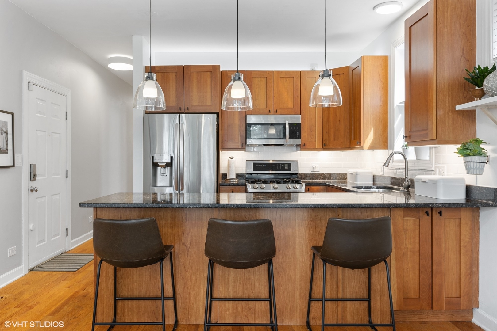 1512 West Victoria Street, Unit 2 Chicago, IL 60660 - Photo 9 of 19 a kitchen with stainless steel appliances a sink and a refrigerator
