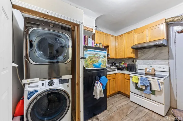 a view of a kitchen with a washer and dryer