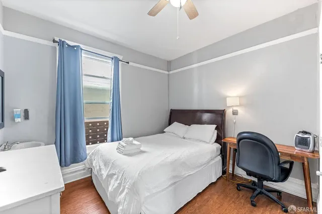 a bedroom with a bed a desk and chair