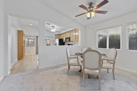 a kitchen with a refrigerator a sink a stove and cabinets