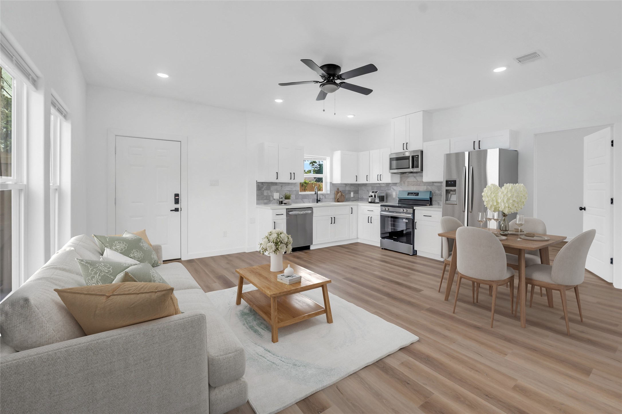 a living room with furniture and kitchen view