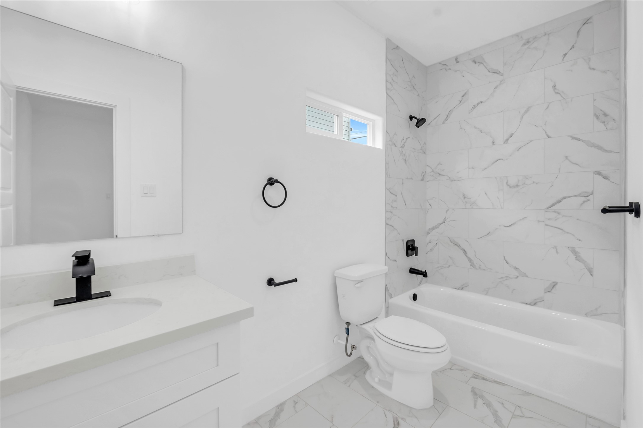 9818 Sandra Street, Unit B Houston, TX 77016 - Photo 11 of 19 a bathroom with a sink a toilet and a bathtub