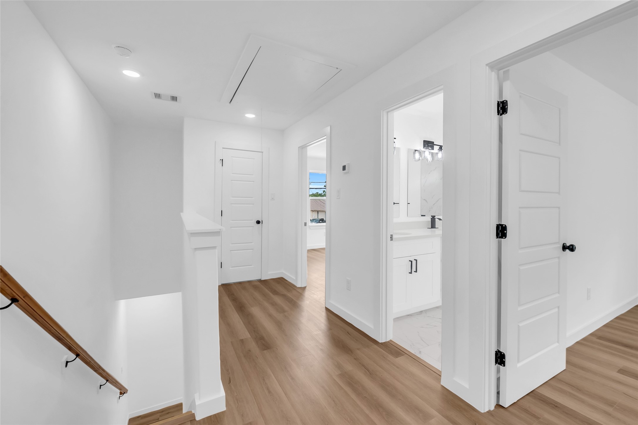 9818 Sandra Street, Unit B Houston, TX 77016 - Photo 12 of 19 a view of a hallway with wooden floor and staircase