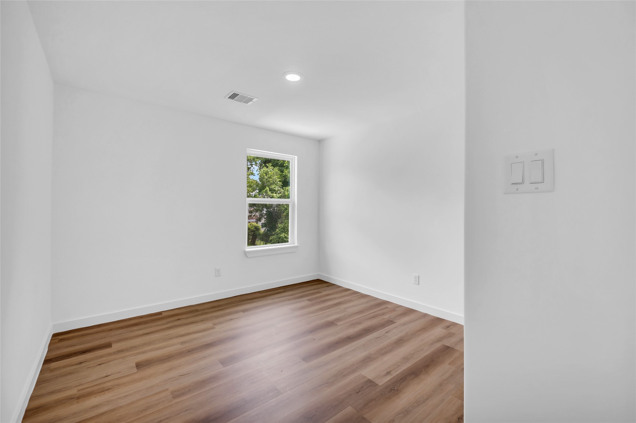 9818 Sandra Street, Unit B Houston, TX 77016 - Photo 14 of 19 a view of an empty room with wooden floor and a window