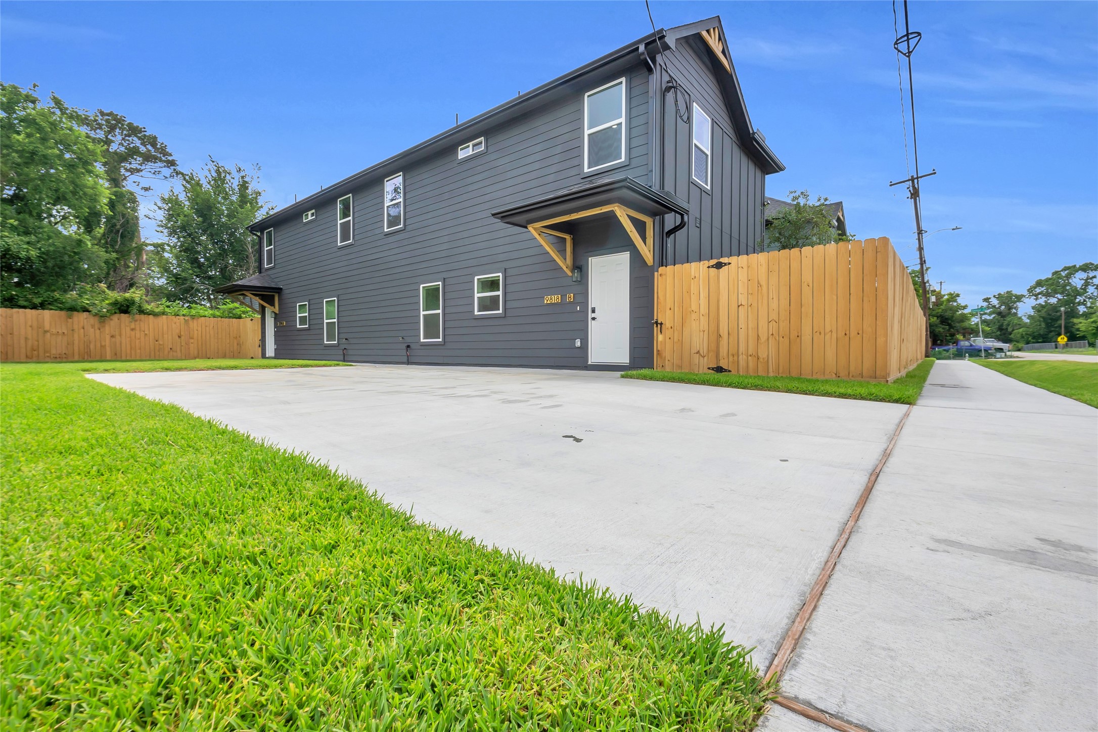9818 Sandra Street, Unit B Houston, TX 77016 - Photo 18 of 19 a front view of a house with a yard and garage