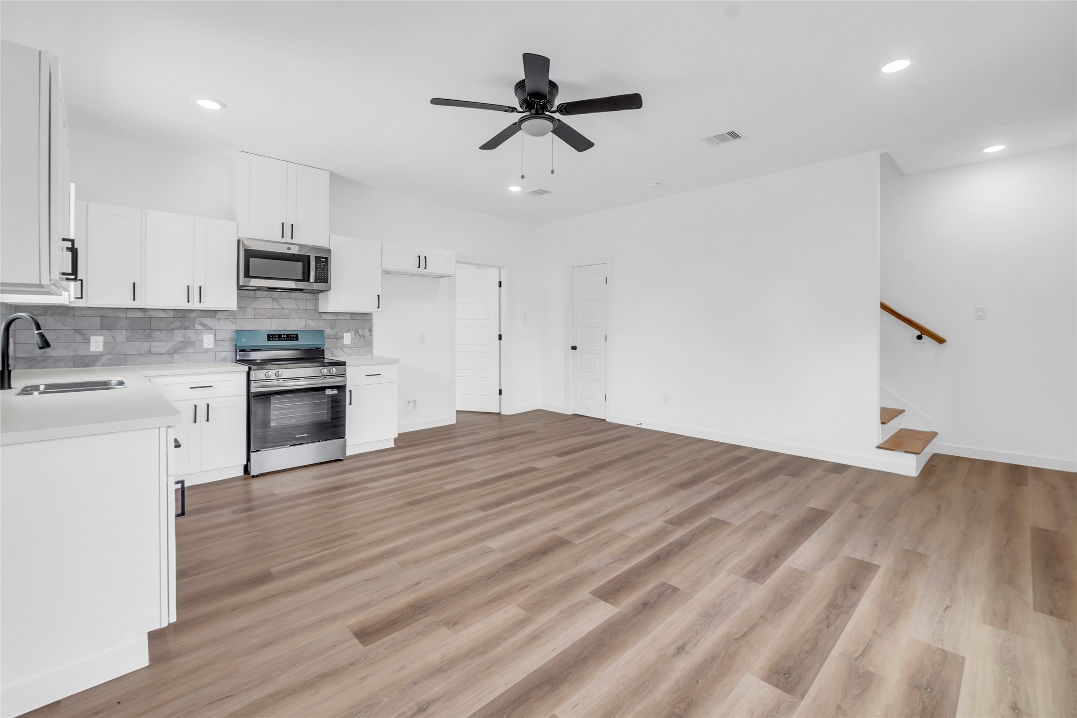 9818 Sandra Street, Unit B Houston, TX 77016 - Photo 3 of 19 a view of kitchen with sink microwave and stove