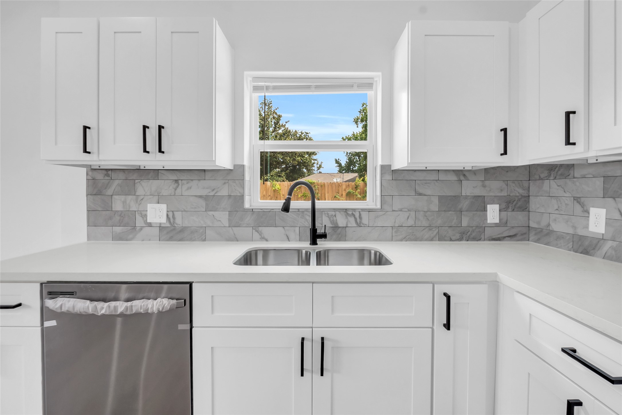 9818 Sandra Street, Unit B Houston, TX 77016 - Photo 4 of 19 a kitchen with white cabinets and a sink