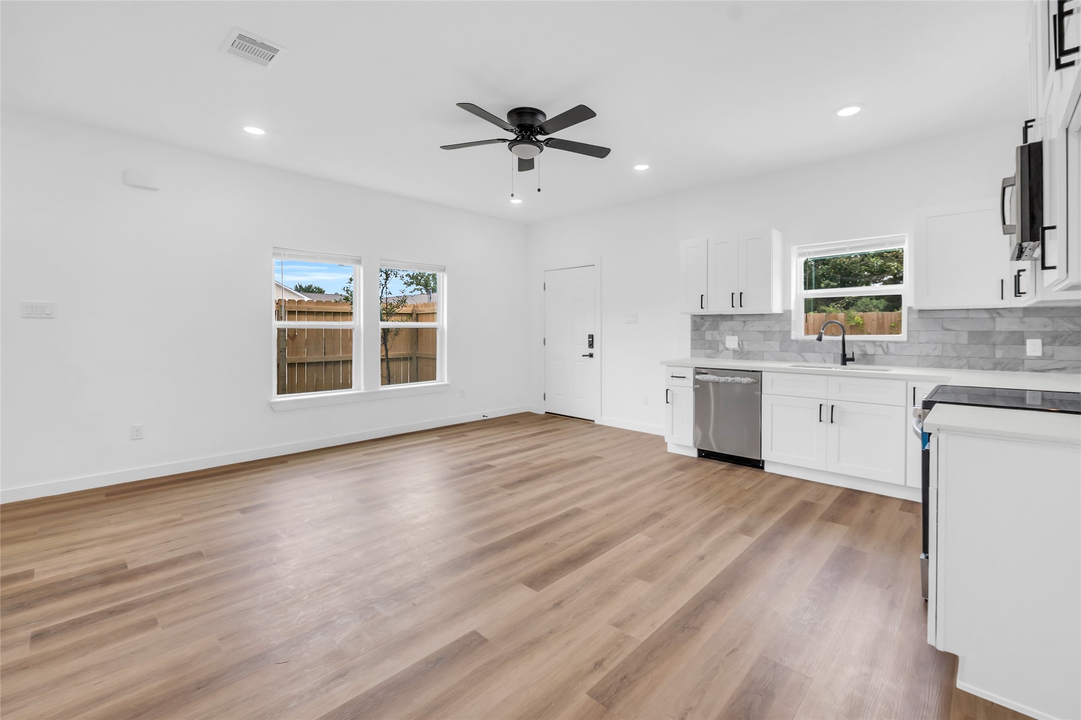 9818 Sandra Street, Unit B Houston, TX 77016 - Photo 5 of 19 a view of a kitchen with a sink hardwood floor and a window