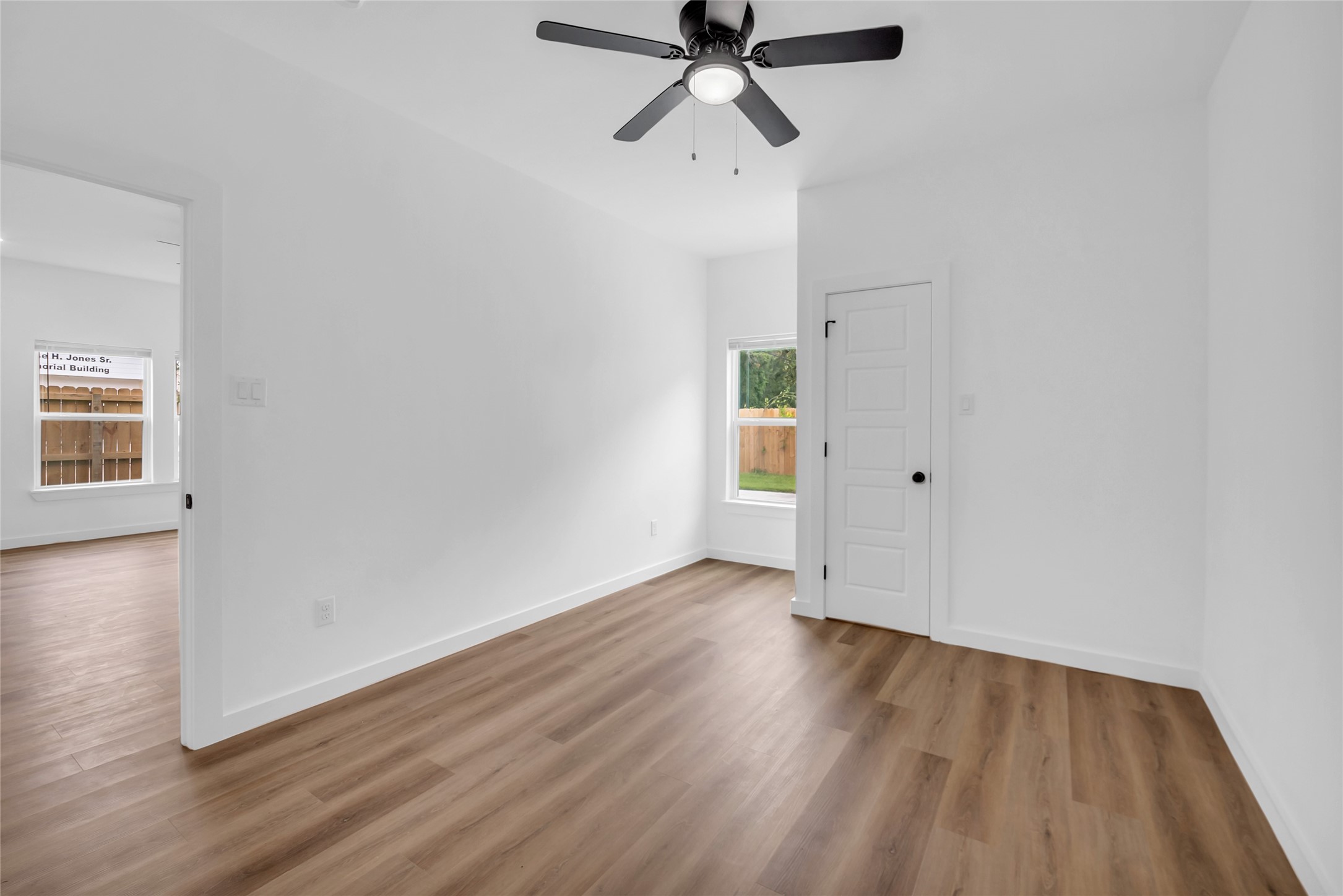 9818 Sandra Street, Unit B Houston, TX 77016 - Photo 8 of 19 wooden floor in an empty room with a window