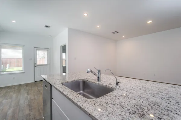 a stove top oven sitting inside of a kitchen