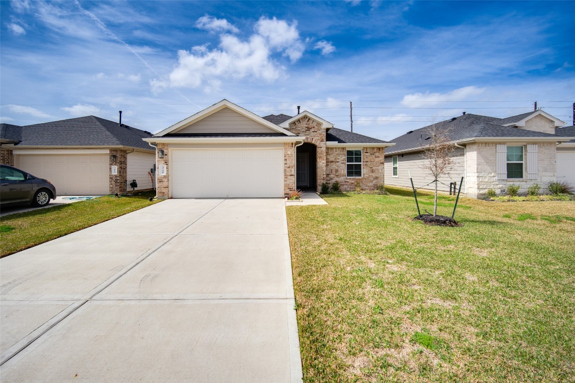 3726 Lanercost Lane Fulshear, TX 77441 - Photo 2 of 30 a front view of a house with a yard and garage