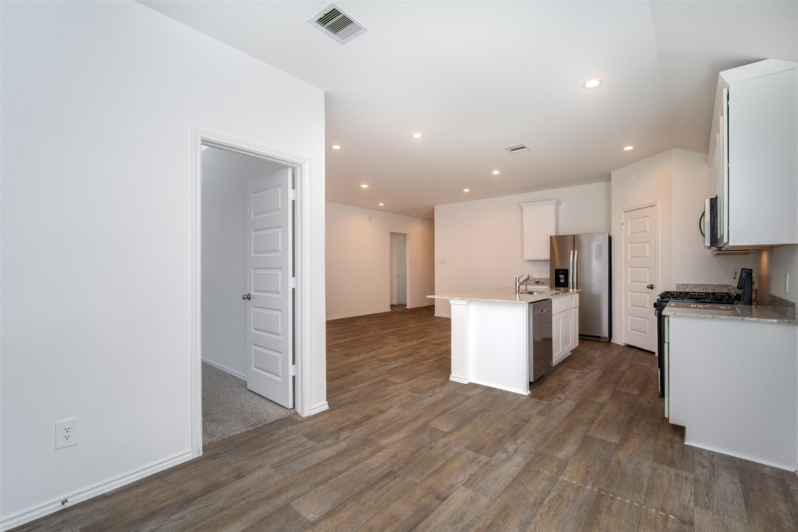 3726 Lanercost Lane Fulshear, TX 77441 - Photo 22 of 30 a view of kitchen with kitchen island wooden floor center island and stainless steel appliances