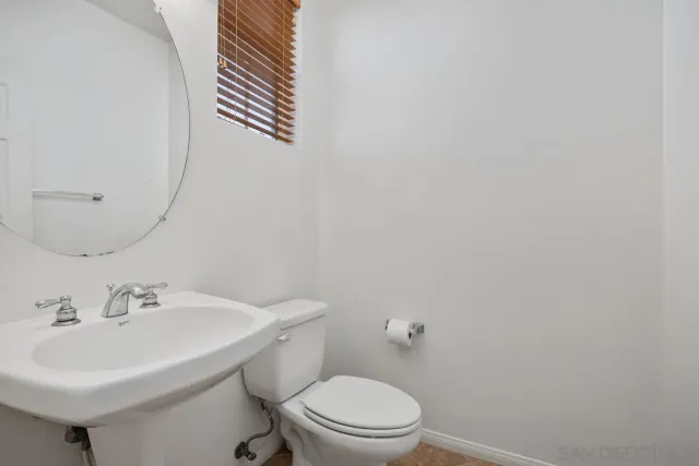 a kitchen with stainless steel appliances granite countertop a sink a refrigerator a stove and white cabinets