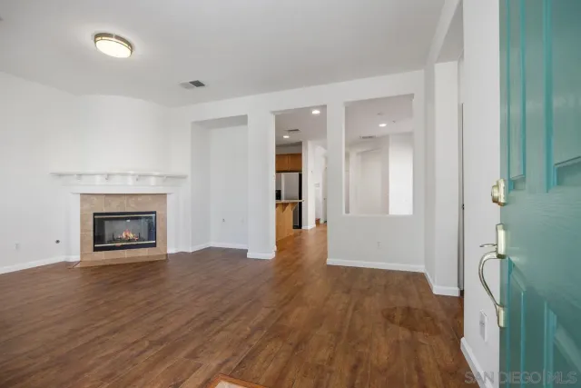 a view of a hallway with wooden floor and entryway