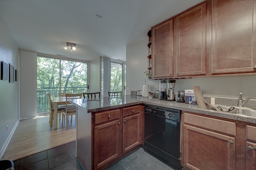 5904 Forest View Road, Unit 2F Lisle, IL 60532 - Photo 13 of 28 a kitchen with a sink stove and cabinets