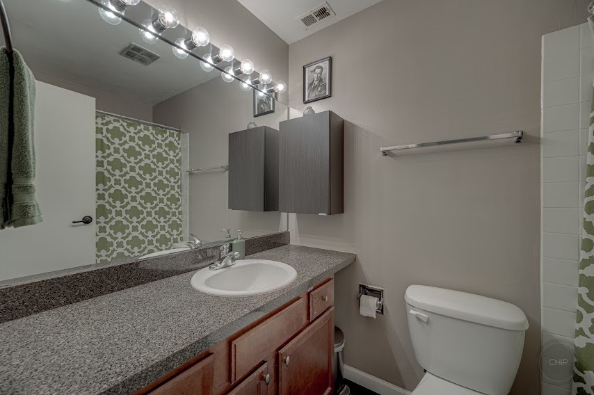 5904 Forest View Road, Unit 2F Lisle, IL 60532 - Photo 14 of 28 a bathroom with a granite countertop sink toilet and a mirror