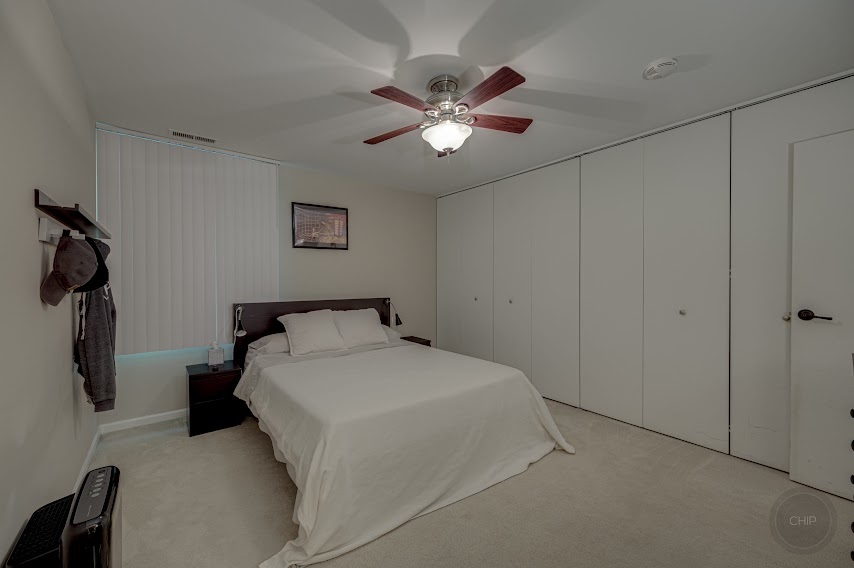 5904 Forest View Road, Unit 2F Lisle, IL 60532 - Photo 17 of 28 a bedroom with a bed and a ceiling fan