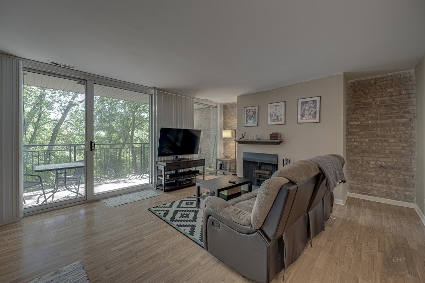 5904 Forest View Road, Unit 2F Lisle, IL 60532 - Photo 3 of 28 a living room with furniture a flat screen tv and a fireplace