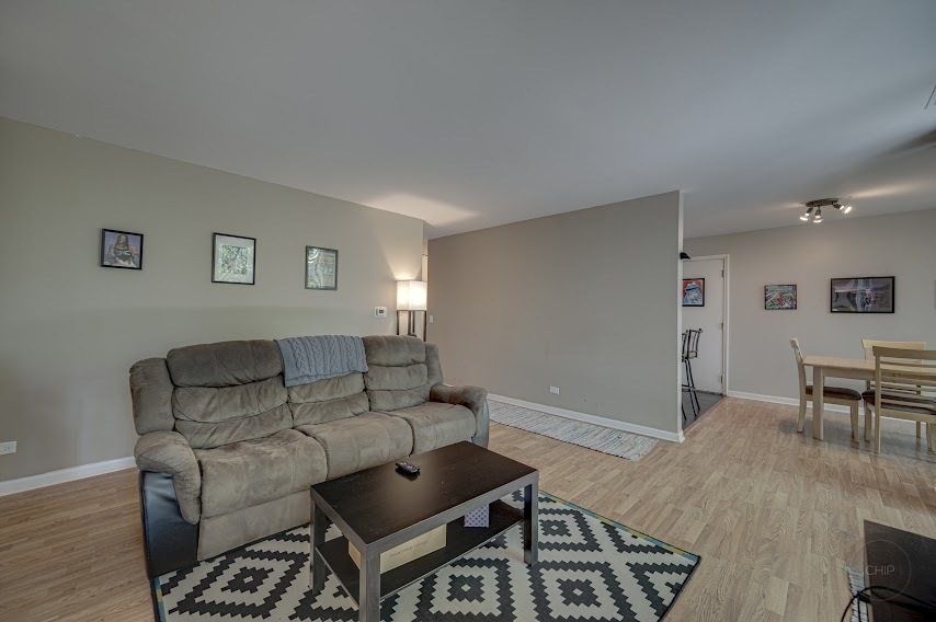 5904 Forest View Road, Unit 2F Lisle, IL 60532 - Photo 5 of 28 a living room with furniture and a wooden floor