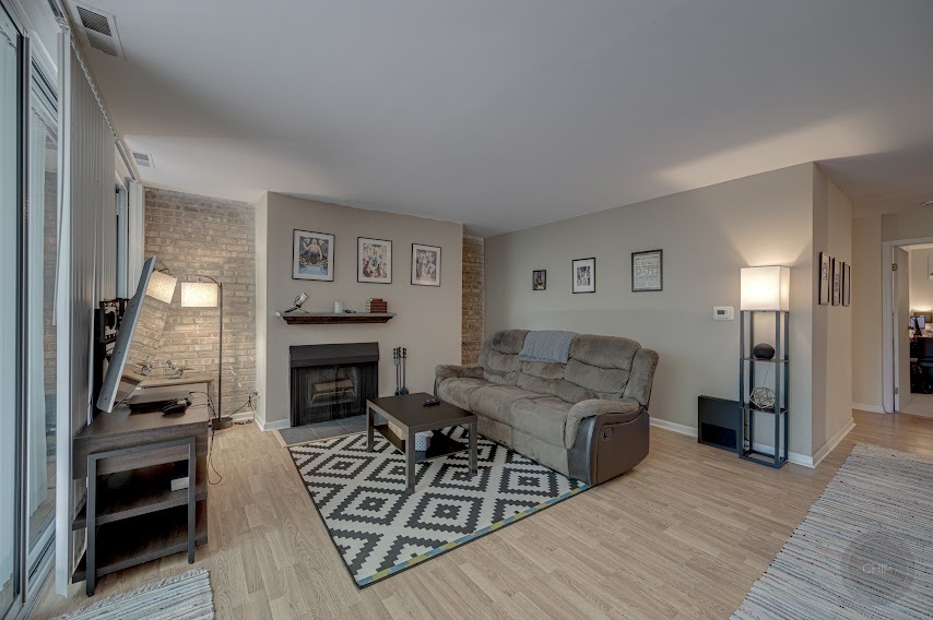 5904 Forest View Road, Unit 2F Lisle, IL 60532 - Photo 6 of 28 a living room with furniture and a fireplace