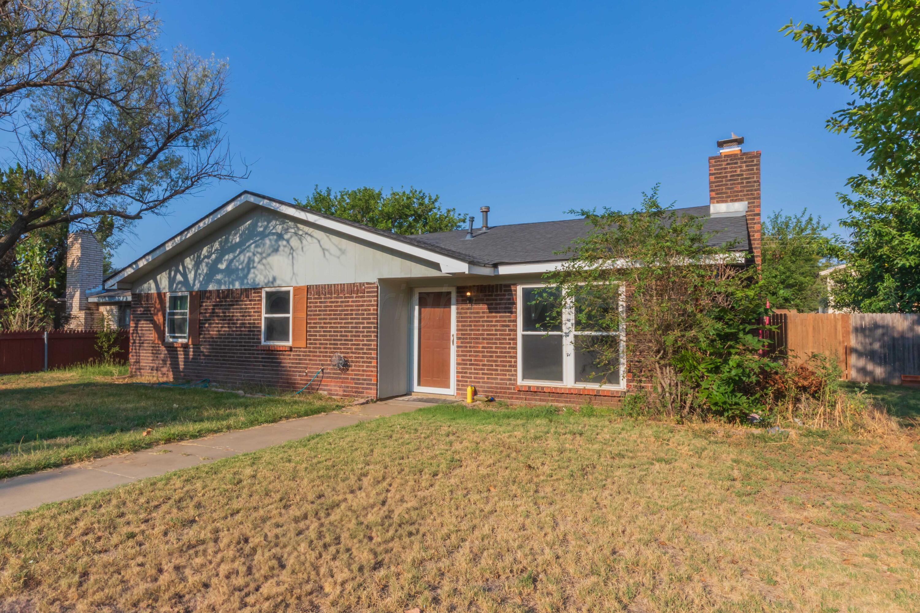 5304 Leigh Avenue Amarillo, TX 79110 - Photo 18 of 36 a front view of a house with a yard and potted plants