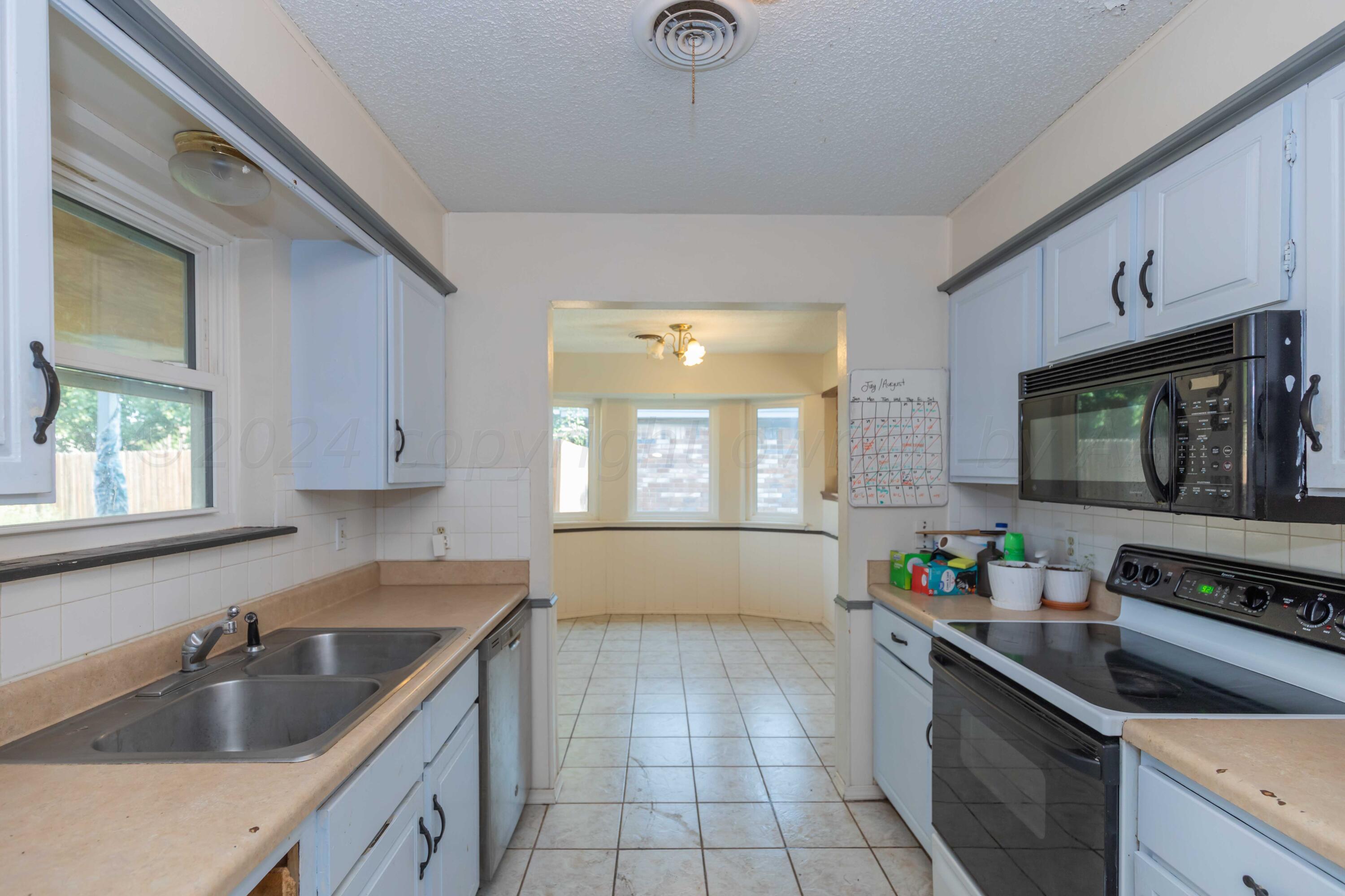 5304 Leigh Avenue Amarillo, TX 79110 - Photo 22 of 36 a kitchen that has a sink and a stove in it