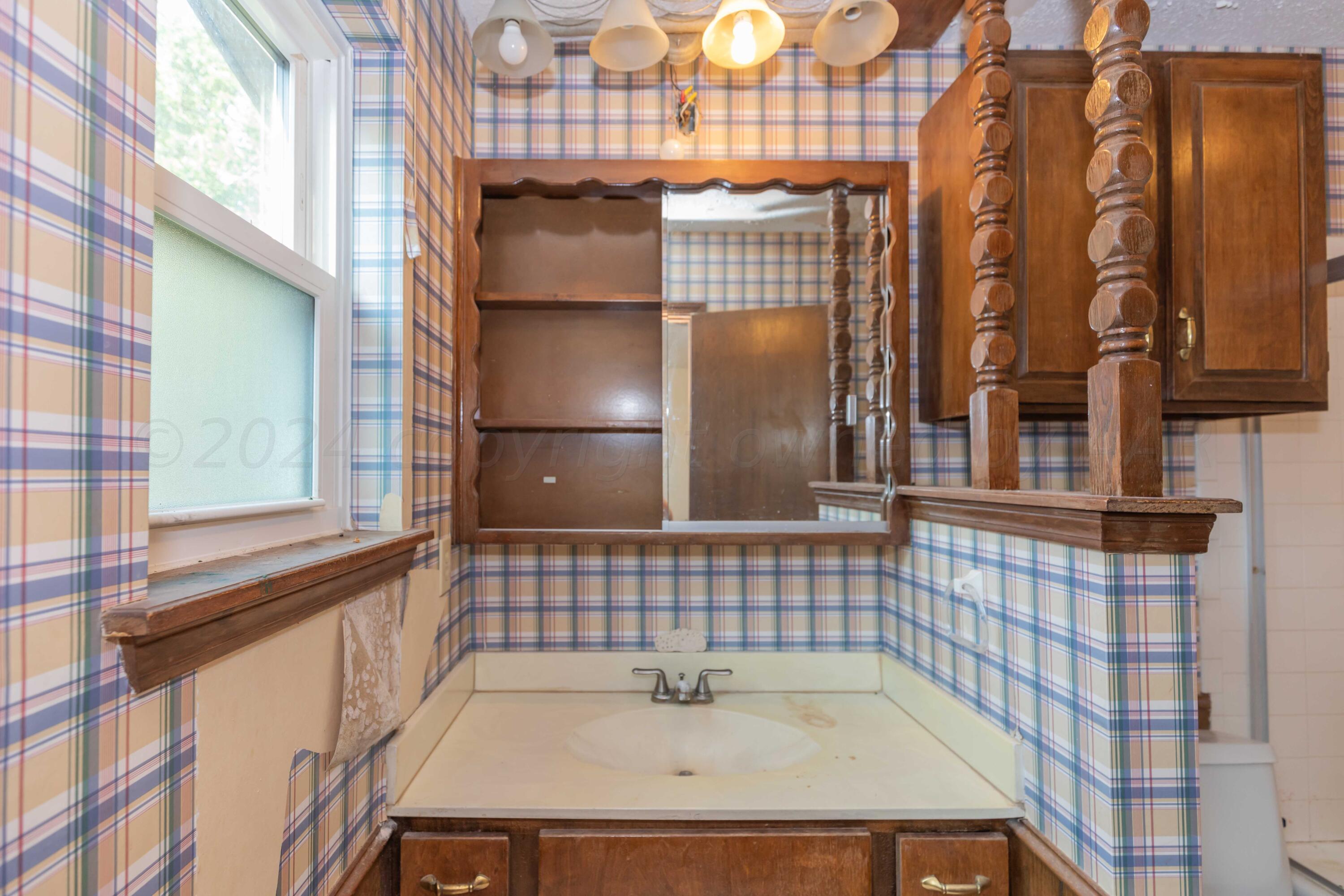 5304 Leigh Avenue Amarillo, TX 79110 - Photo 28 of 36 a bathroom with a sink and a shower