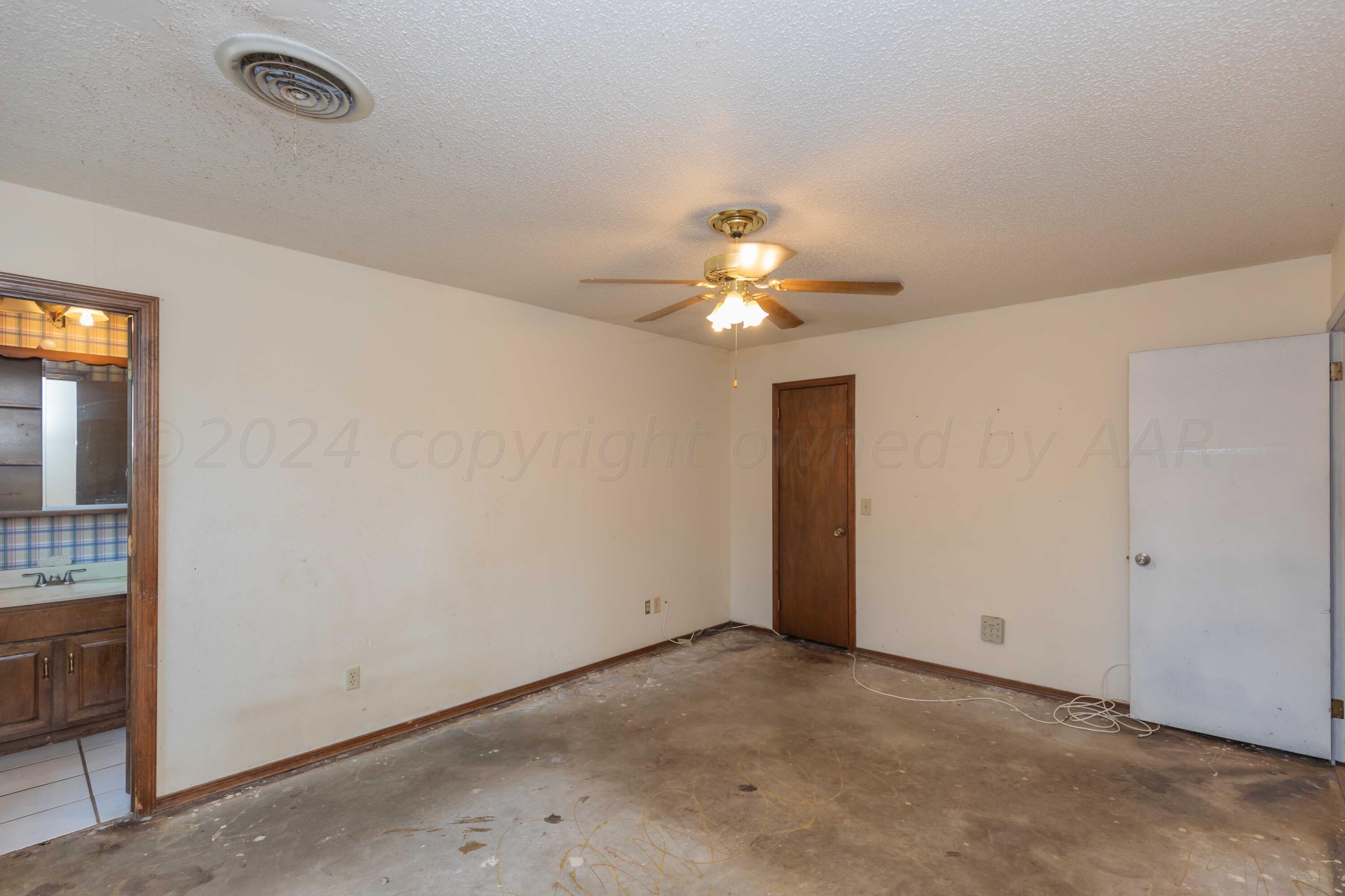 5304 Leigh Avenue Amarillo, TX 79110 - Photo 32 of 36 an empty room with a chandelier fan