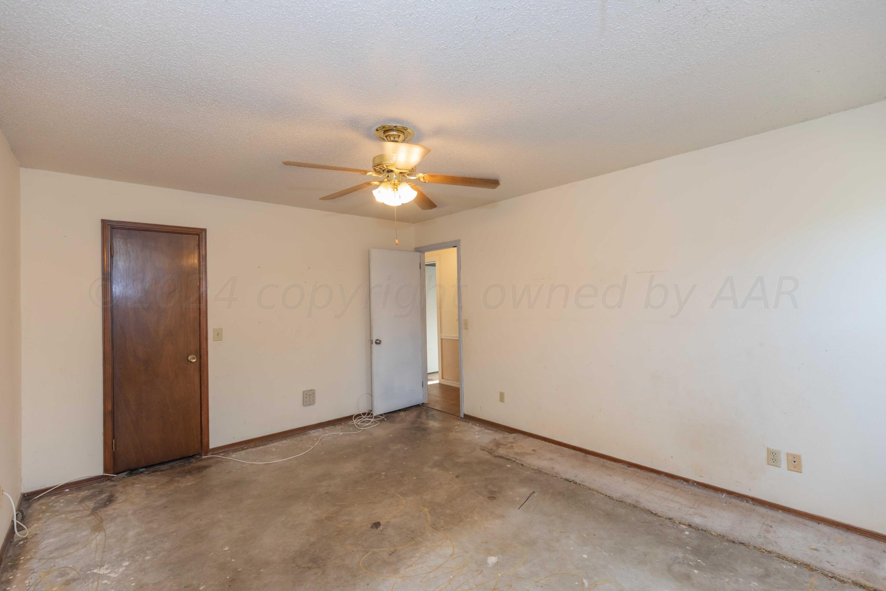 5304 Leigh Avenue Amarillo, TX 79110 - Photo 33 of 36 an empty room with a chandelier fan and a table
