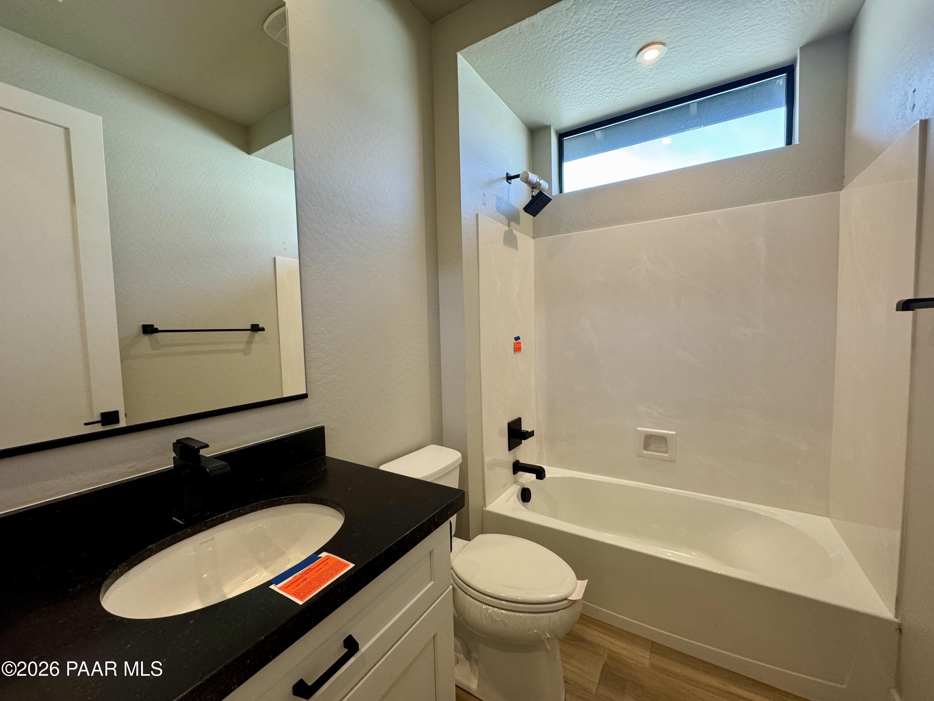 5556 East Killen Loop Prescott Valley, AZ 86314 - Photo 16 of 27 a bathroom with a sink a toilet a mirror and shower